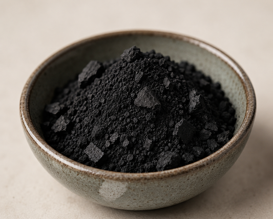 ecochar, biochar powder in a textured ceramic bowl on a beige background